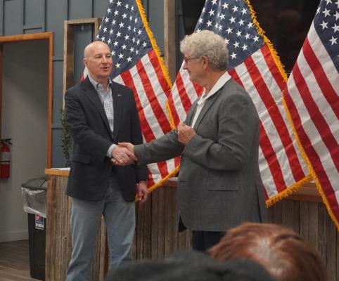 Community Engagement Senator Pete Ricketts (left) shakes hands with Norm Krug at The Collective in Central City, where Ricketts was introduced before delivering a speech on border policy and the importance of leadership in Washington D.C.
