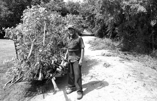 Tom Wagner helps during tree removal on the Dark Island Trail.
